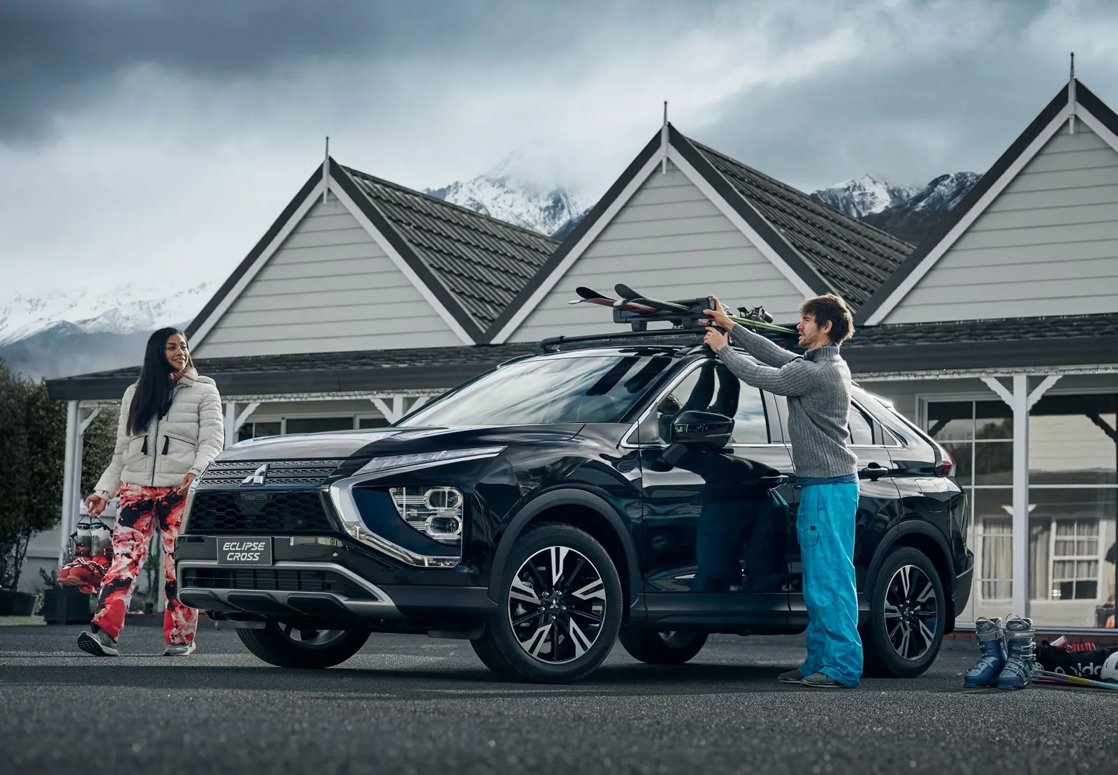 Loading skis onto a Mitsubishi Eclipse Cross at a mountain lodge