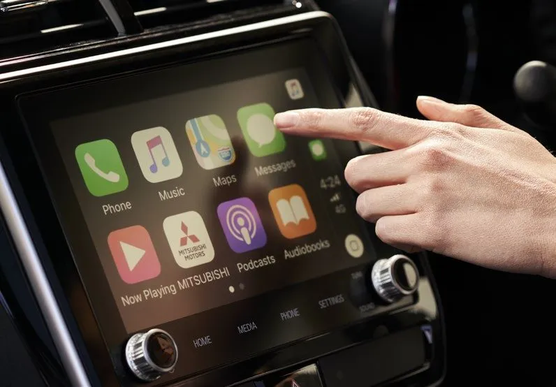 Hand using the ASX 8-inch touchscreen with Apple CarPlay