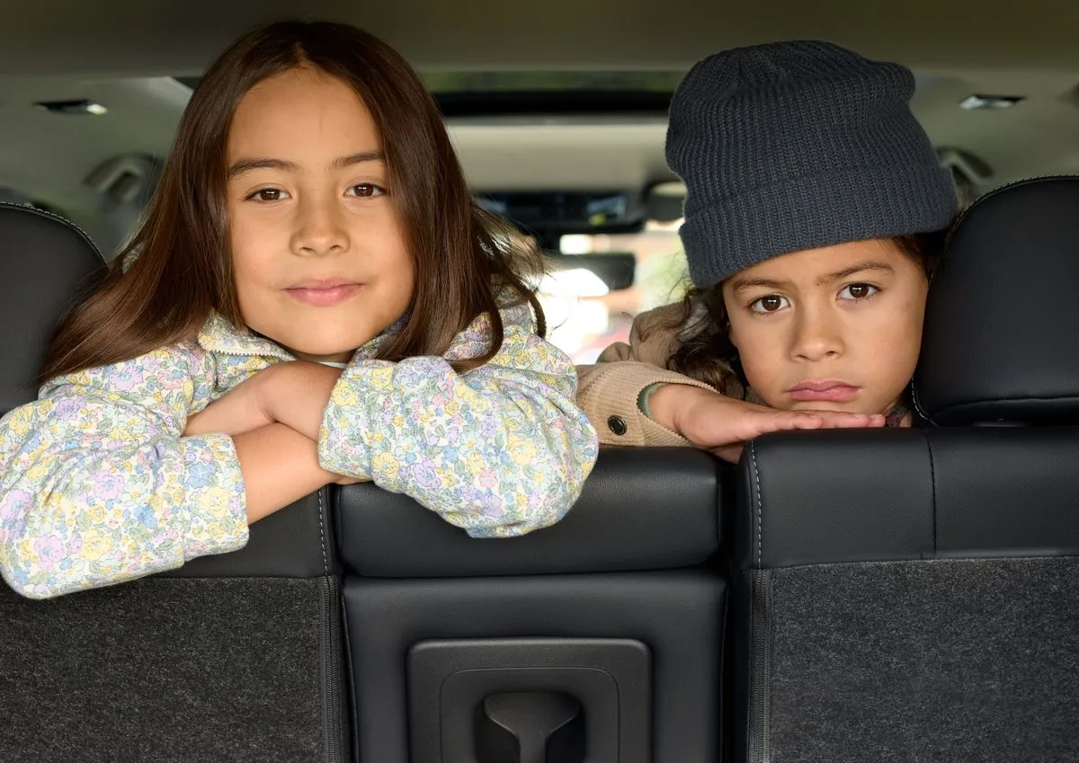 Children seated in the rear of an Outlander