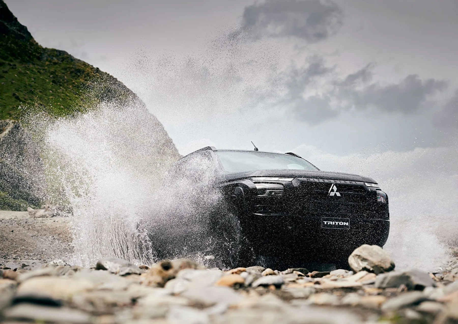 Mitsubishi Triton driving through a river crossing